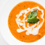This plant based tomato basil soup is creamy and packed with vegetables. It is delicious and something your family will ask you to make on repeat!
